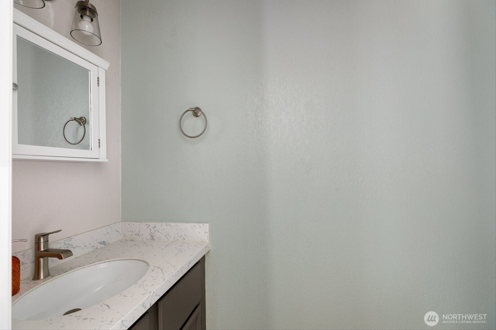 566 Creekside Terrace, Unit 101 Langley, WA 98260 - Photo 21 of 31 a bathroom with a granite countertop sink vanity and mirror