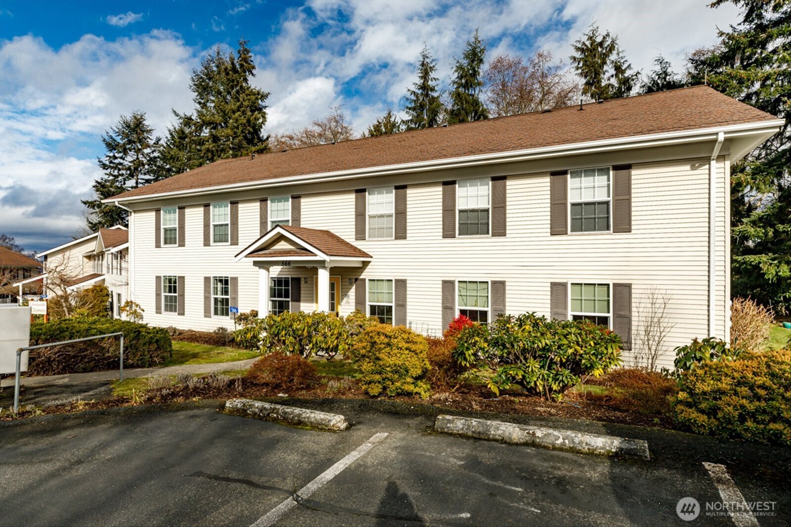 566 Creekside Terrace, Unit 101 Langley, WA 98260 - Photo 25 of 31 a front view of a house with a garden