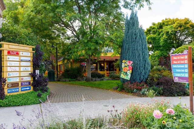 a front view of a house with a yard and fountain