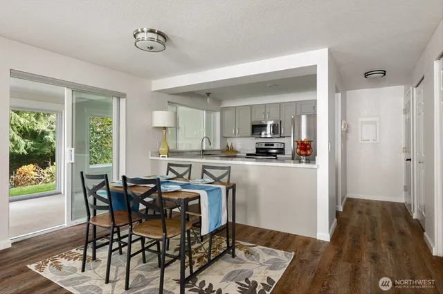 a view of a dining room with furniture and wooden floor