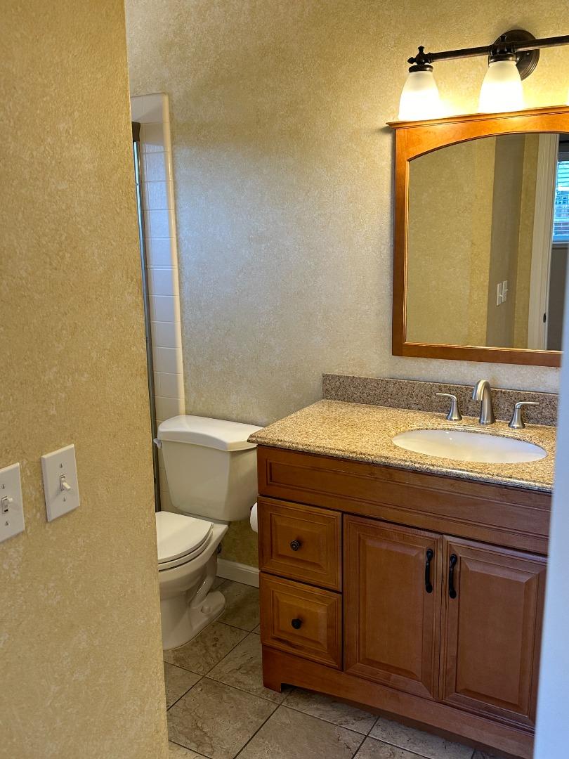 2046 Anthony Drive Campbell, CA 95008 - Photo 11 of 18 a bathroom with a granite countertop toilet a sink and a mirror