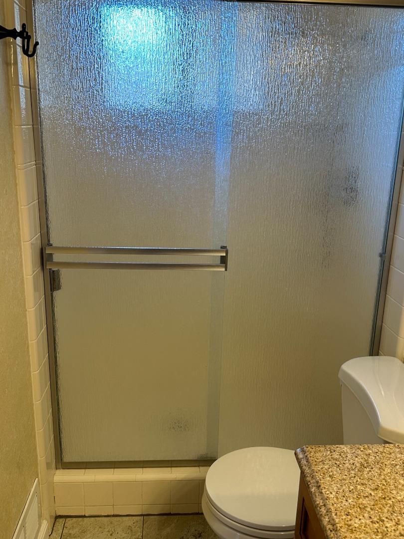 2046 Anthony Drive Campbell, CA 95008 - Photo 12 of 18 a white toilet sitting next to a shower curtain