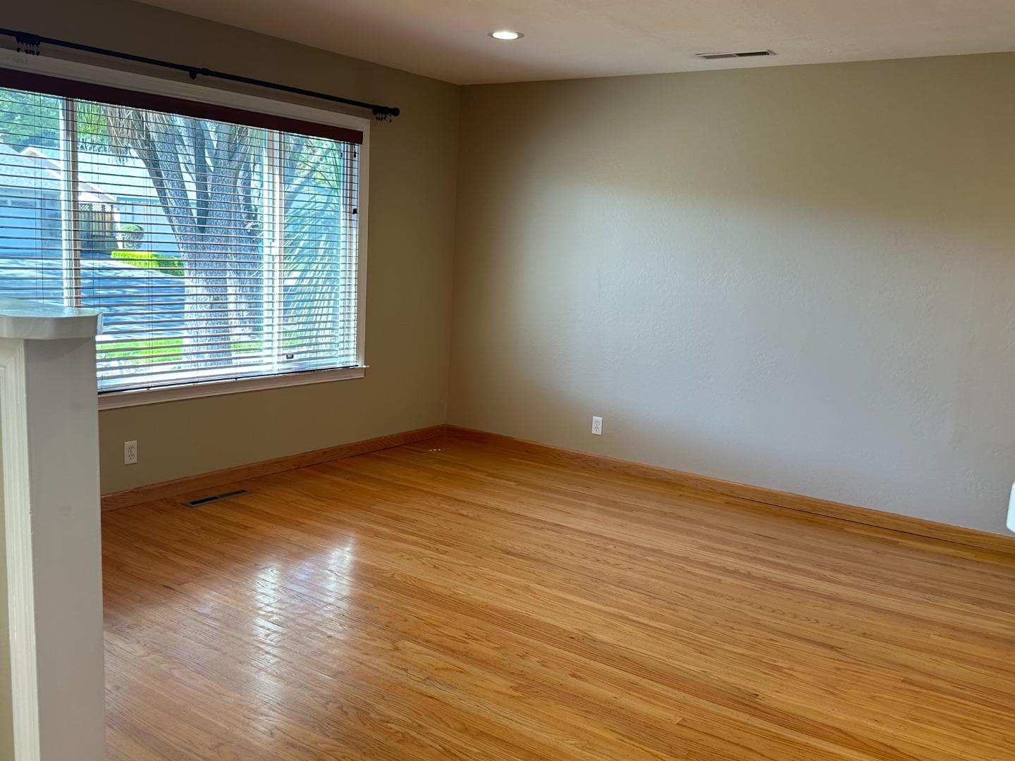 2046 Anthony Drive Campbell, CA 95008 - Photo 2 of 18 a view of an empty room with wooden floor and a window