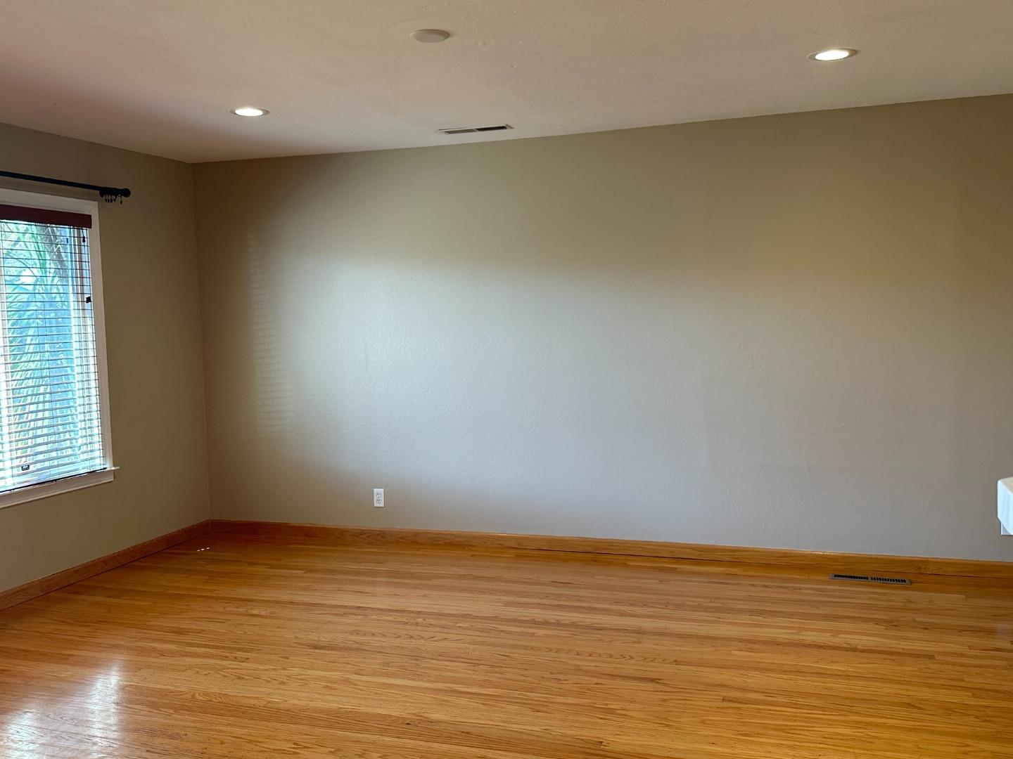 2046 Anthony Drive Campbell, CA 95008 - Photo 3 of 18 a view of an empty room with wooden floor and a window
