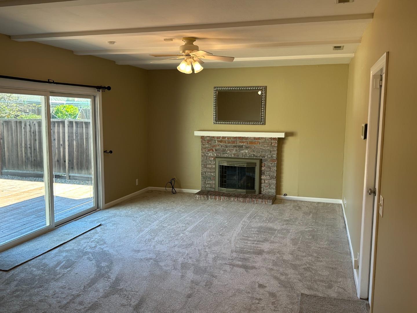 2046 Anthony Drive Campbell, CA 95008 - Photo 8 of 18 a view of empty room with floor to ceiling window and fireplace