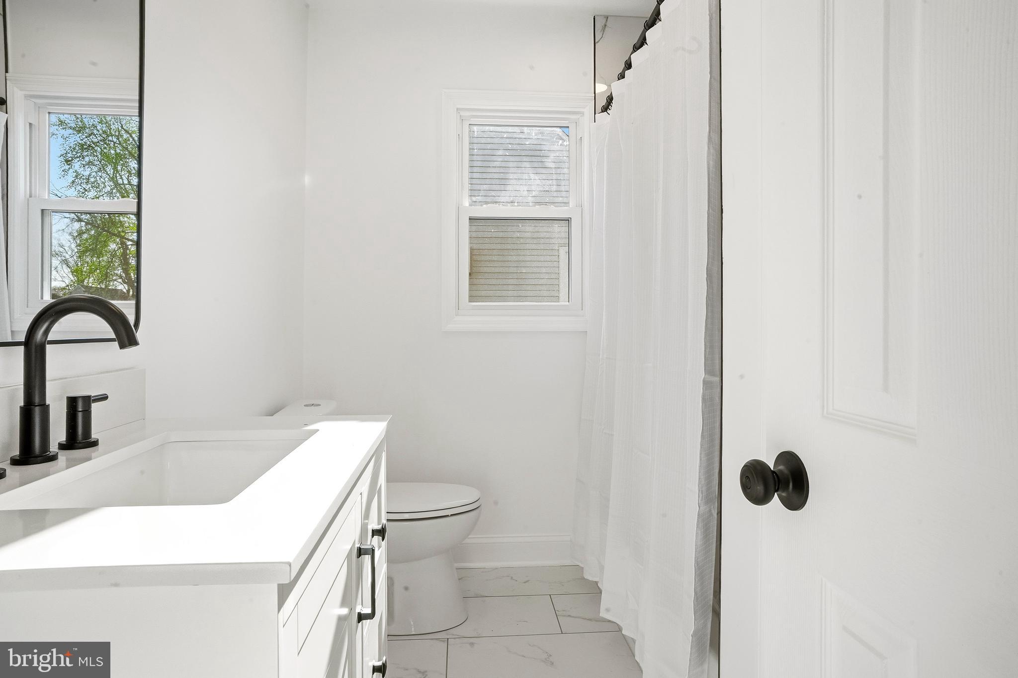601 Evesham Avenue West Magnolia, NJ 08049 - Photo 14 of 20 a bathroom with a sink toilet and shower