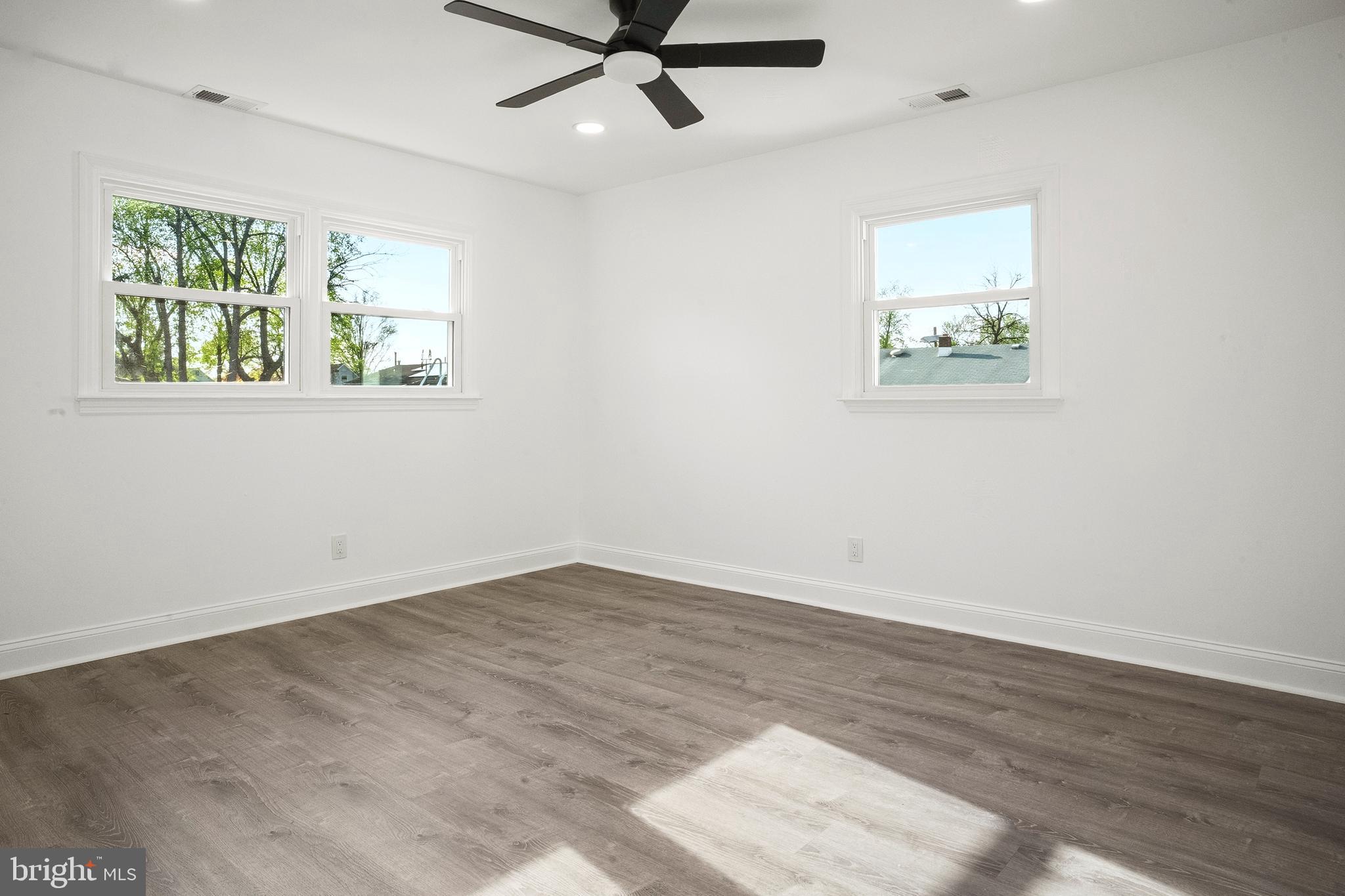 601 Evesham Avenue West Magnolia, NJ 08049 - Photo 15 of 20 an empty room with wooden floor ceiling fan and windows