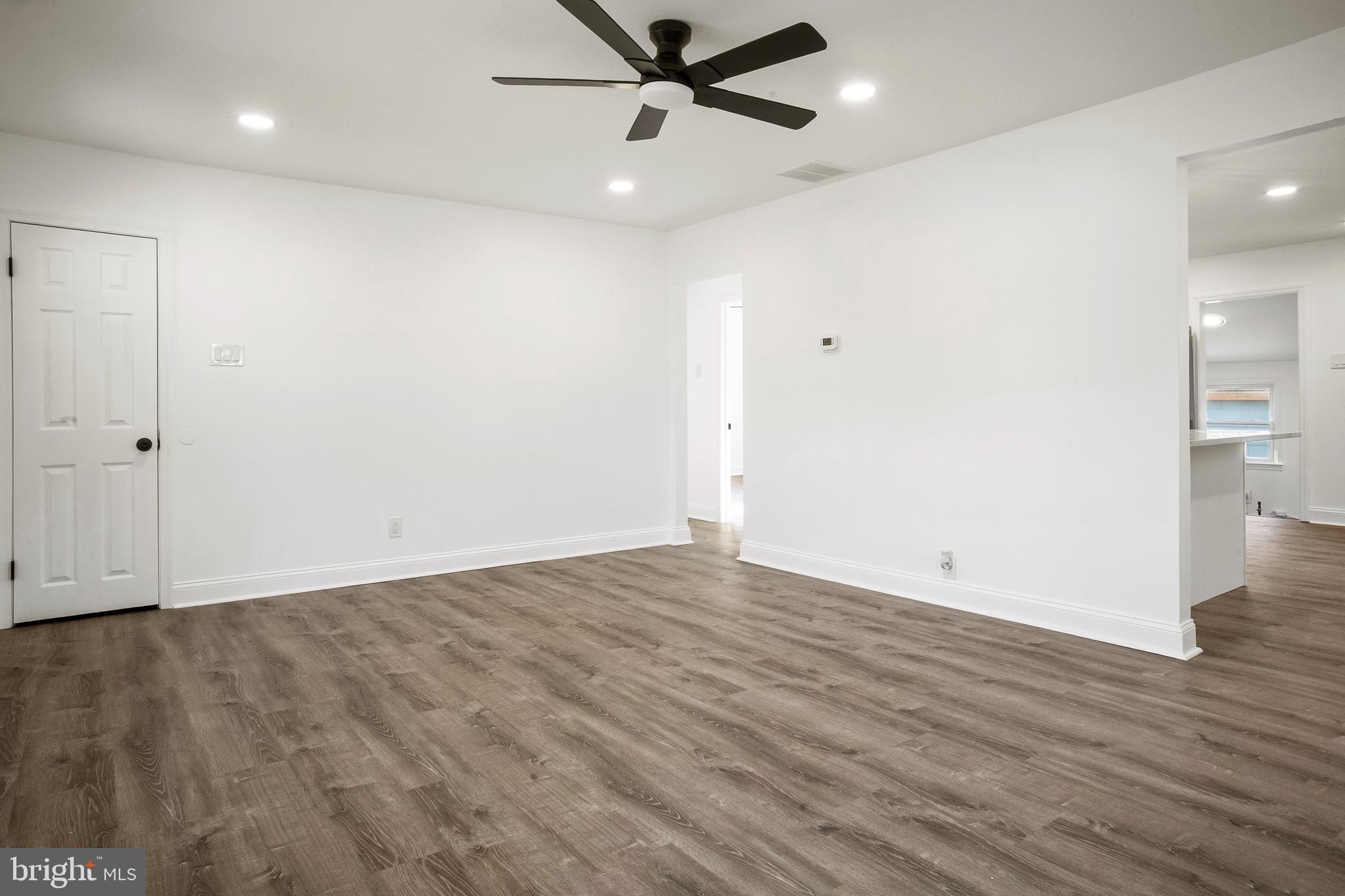 601 Evesham Avenue West Magnolia, NJ 08049 - Photo 4 of 20 an empty room with wooden floor and a ceiling fan