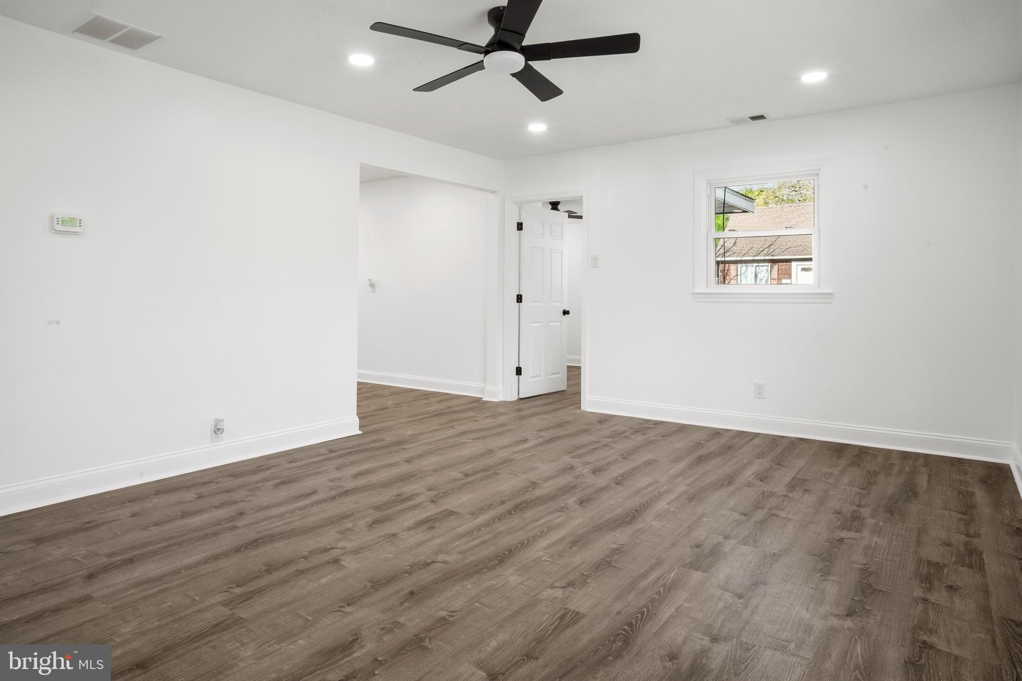 601 Evesham Avenue West Magnolia, NJ 08049 - Photo 5 of 20 an empty room with wooden floor ceiling fan and windows
