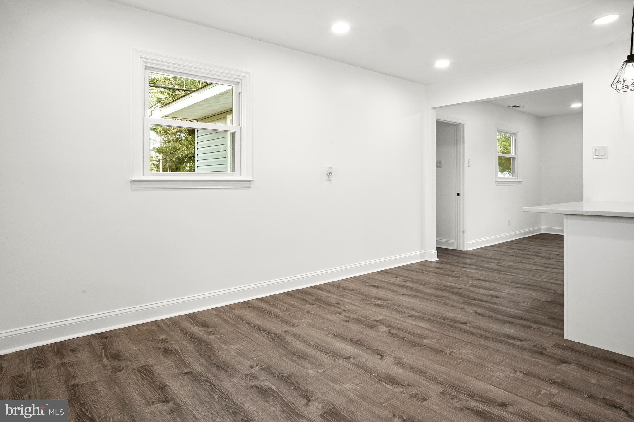 601 Evesham Avenue West Magnolia, NJ 08049 - Photo 10 of 20 an empty room with wooden floor and windows