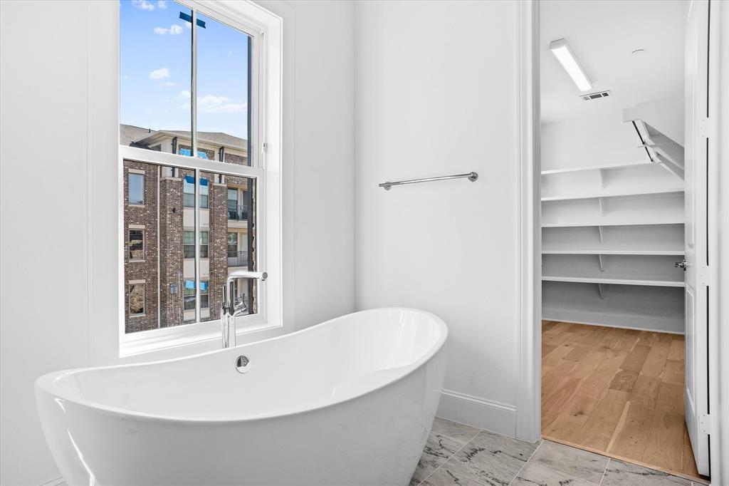 14953 Holly Street Addison, TX 75001 - Photo 4 of 17 a bathroom with a bathtub and a sink