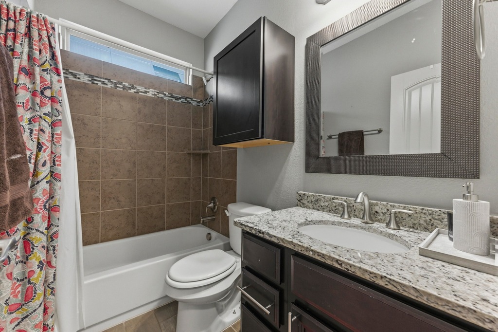 5425 Cherokee Draw Road Austin, TX 78738 - Photo 30 of 40 Granite counters and tiled shower enclosure provide a refreshing full bath experience.