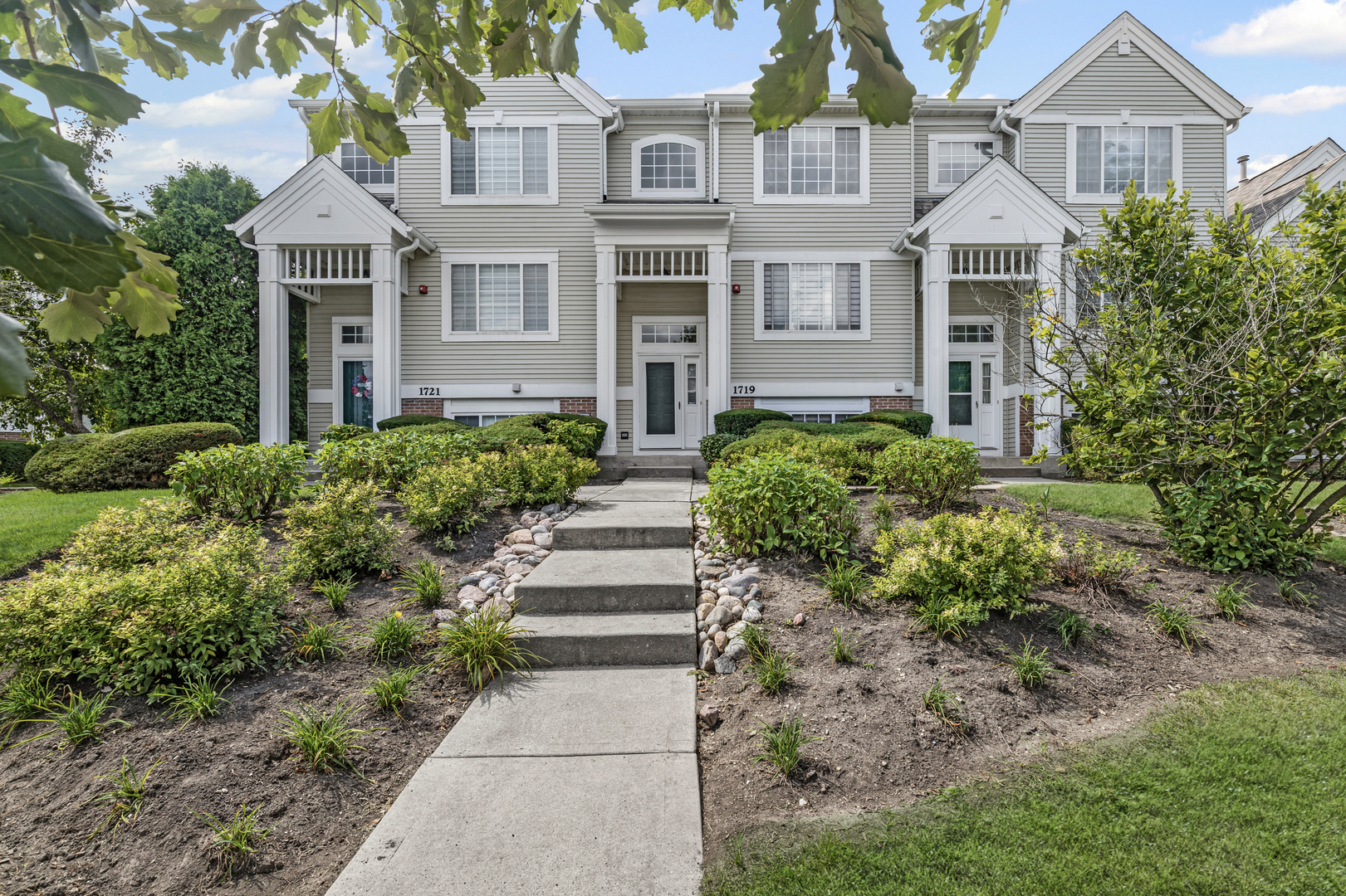 1719 Sienna Court Wheeling, IL 60090 - Photo 1 of 18 a front view of a house with a yard