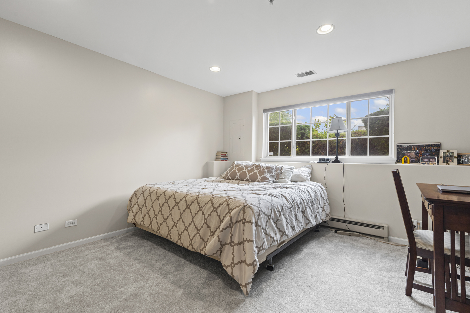 1719 Sienna Court Wheeling, IL 60090 - Photo 17 of 18 a spacious bedroom with a bed and a table in it