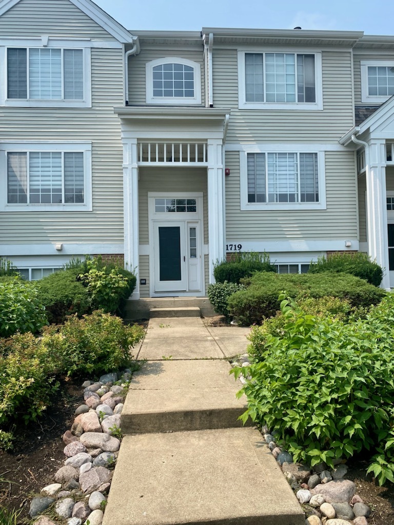 1719 Sienna Court Wheeling, IL 60090 - Photo 2 of 18 a front view of a house with a yard