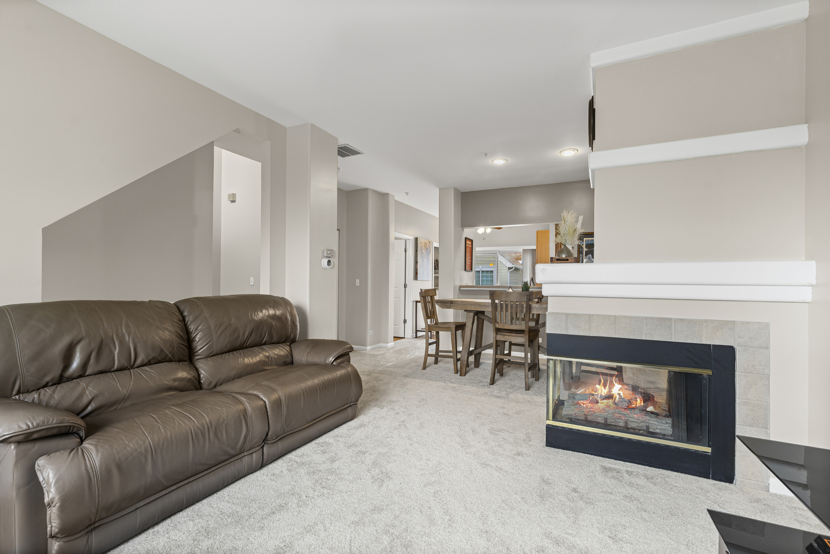 1719 Sienna Court Wheeling, IL 60090 - Photo 4 of 18 a living room with furniture a fireplace a rug and a window