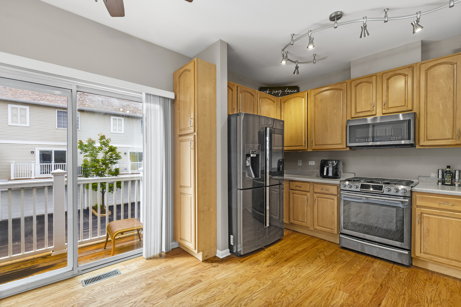1719 Sienna Court Wheeling, IL 60090 - Photo 5 of 18 a kitchen with stainless steel appliances granite countertop a refrigerator a stove top oven and cabinets