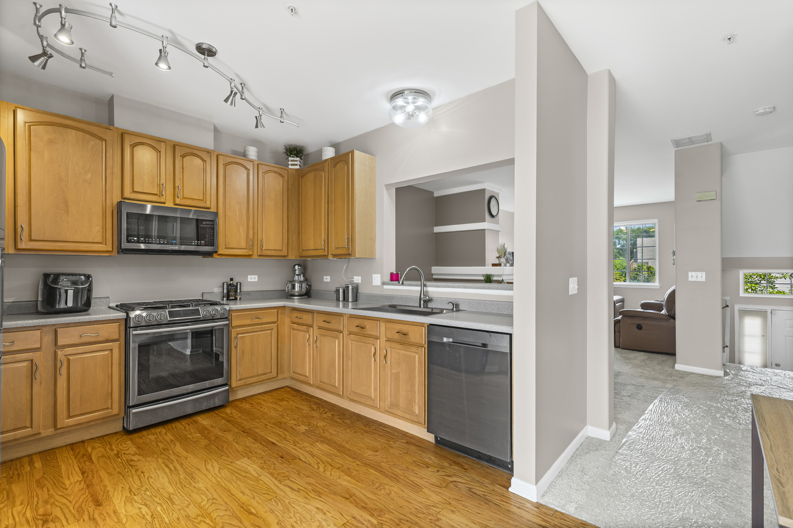 1719 Sienna Court Wheeling, IL 60090 - Photo 6 of 18 a kitchen with stainless steel appliances granite countertop a stove top oven a sink dishwasher and a refrigerator