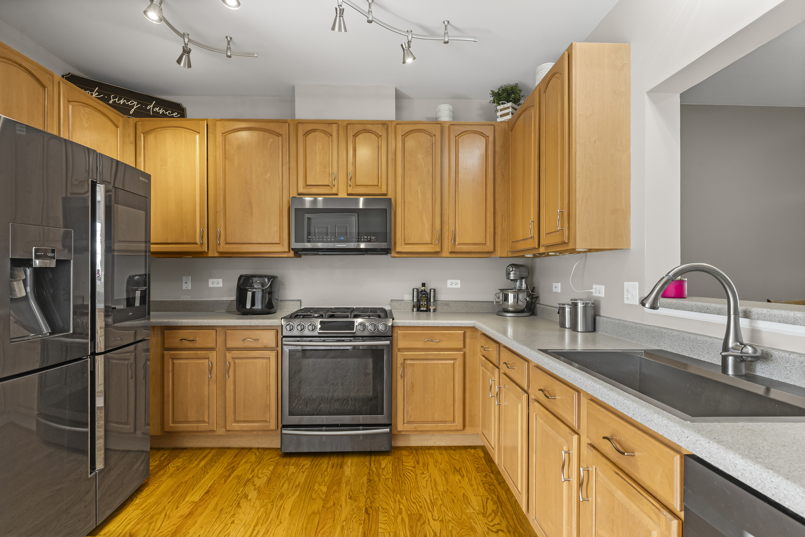 1719 Sienna Court Wheeling, IL 60090 - Photo 7 of 18 a kitchen with stainless steel appliances granite countertop a sink stove and refrigerator