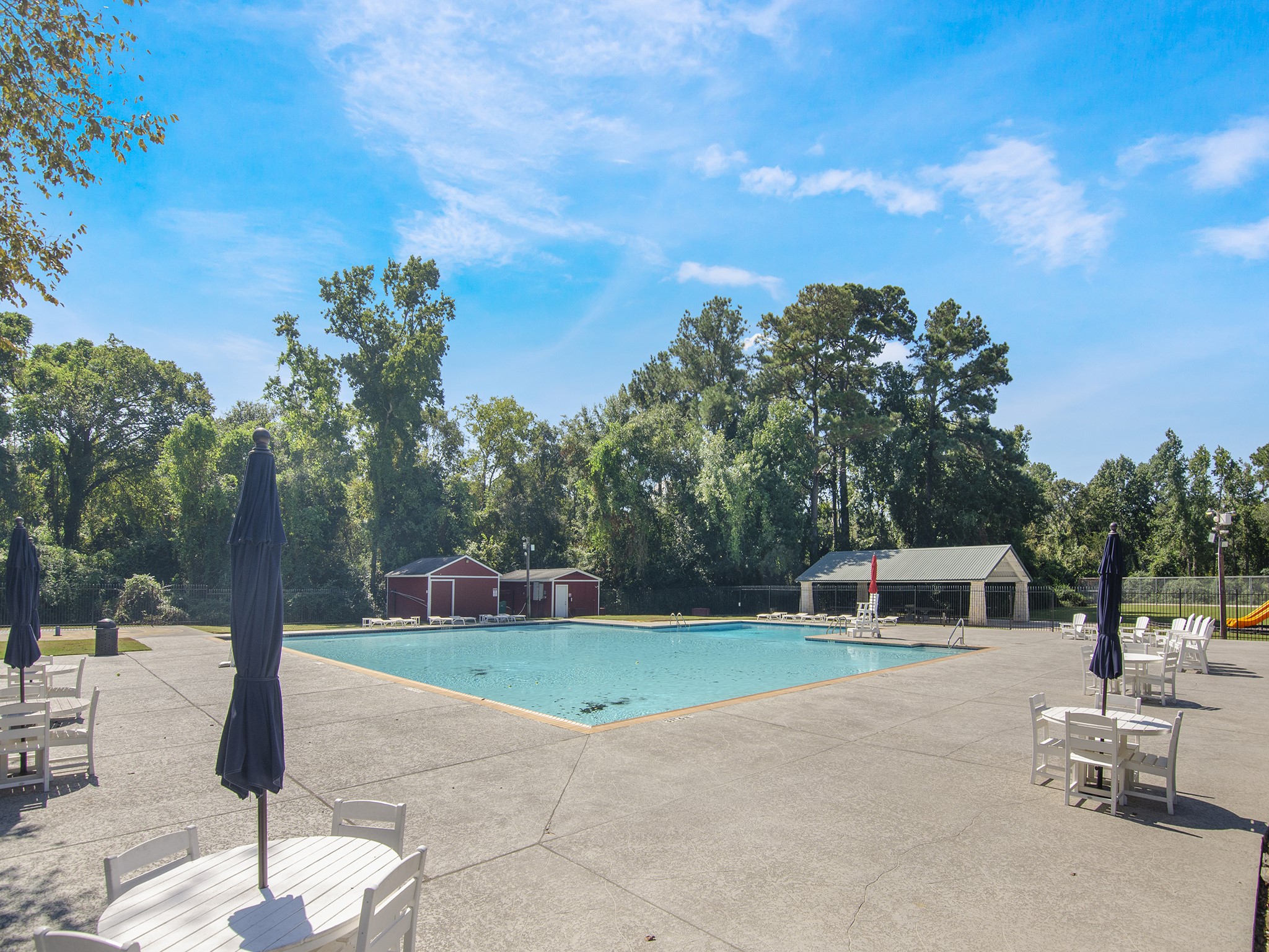 532 Raleigh Drive Conroe, TX 77302 - Photo 35 of 40 This spacious pool deck offers plenty of room to relax with tables, chairs & umbrellas.