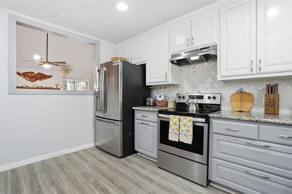 685 Cardinal Ridge Road Burleson, TX 76028 - Photo 12 of 40 a kitchen with stainless steel appliances granite countertop a refrigerator and a stove top oven