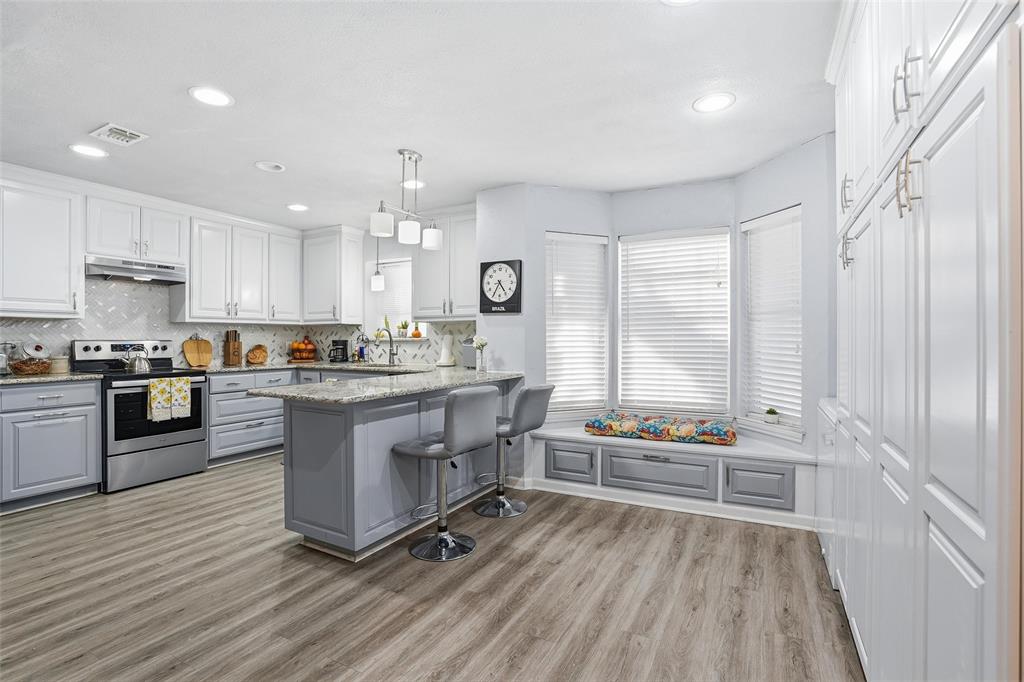 685 Cardinal Ridge Road Burleson, TX 76028 - Photo 13 of 40 a kitchen with granite countertop a stove a sink and a refrigerator