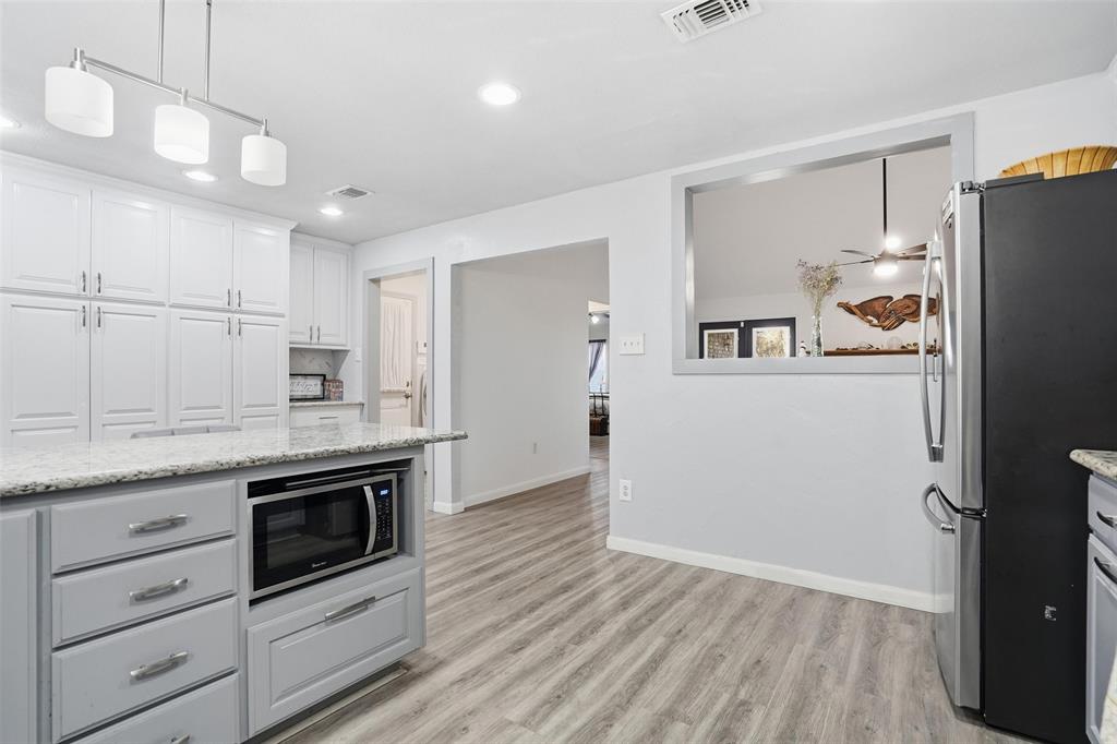 685 Cardinal Ridge Road Burleson, TX 76028 - Photo 14 of 40 a kitchen with granite countertop a refrigerator stove and sink
