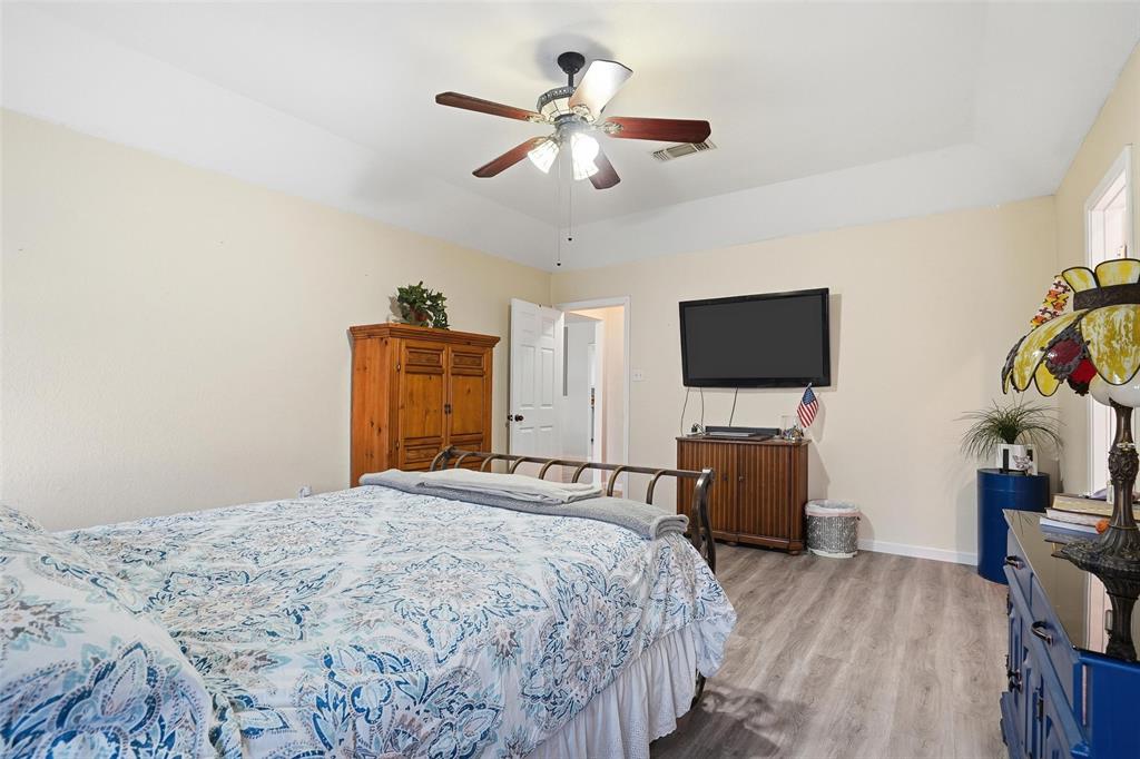 685 Cardinal Ridge Road Burleson, TX 76028 - Photo 19 of 40 a bedroom with a bed and a flat screen tv