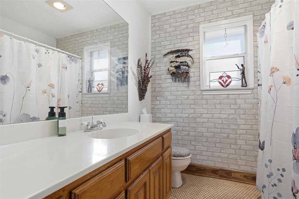 685 Cardinal Ridge Road Burleson, TX 76028 - Photo 31 of 40 a bathroom with a sink a toilet and shower