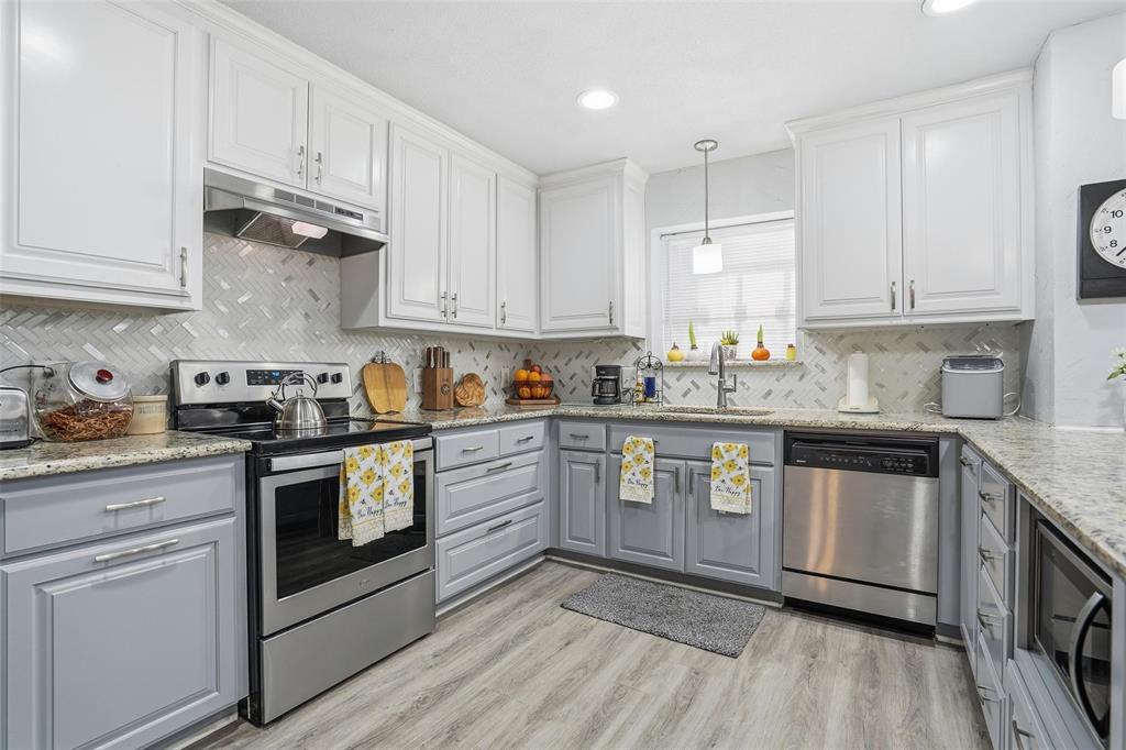685 Cardinal Ridge Road Burleson, TX 76028 - Photo 10 of 40 a kitchen with granite countertop white cabinets and white appliances