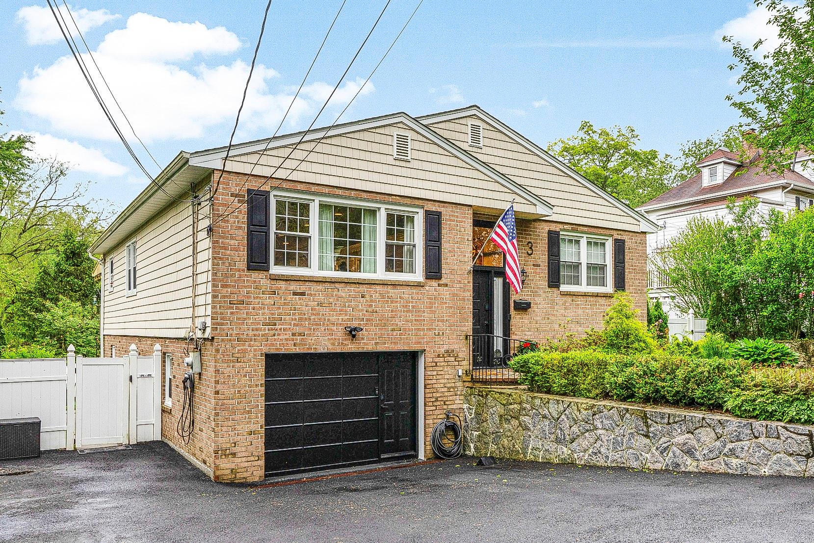 3 Cross Road Ardsley, NY 10502 - Photo 1 of 1 View of front of house featuring a garage, brick siding, a gate, and asphalt driveway