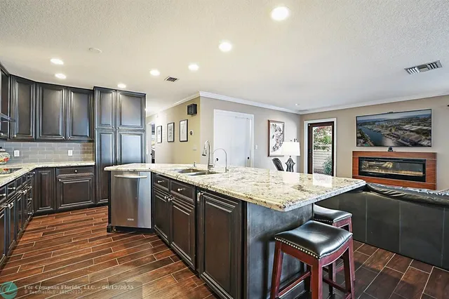 a kitchen with granite countertop cabinets and refrigerator