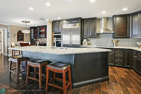 a dining room with furniture and a floor to ceiling window