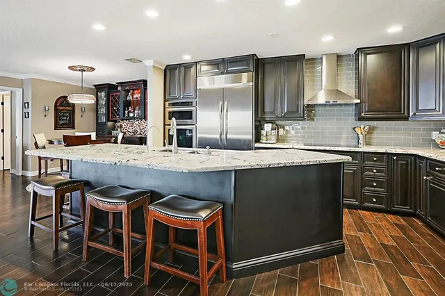 a dining room with furniture and a floor to ceiling window