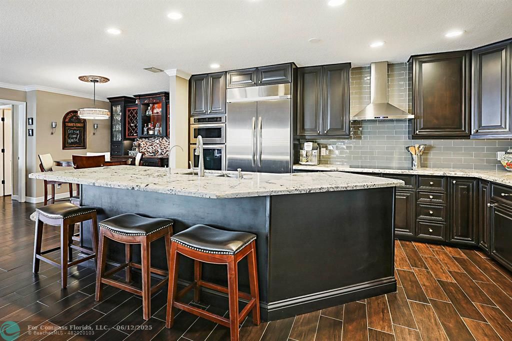 2743 Northeast 28th Court, Unit 3 Lighthouse Point, FL 33064 - Photo 15 of 56 a kitchen with granite countertop cabinets and refrigerator