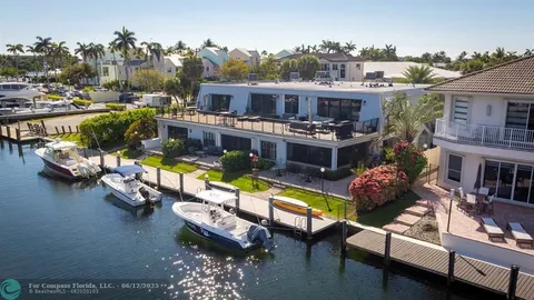 an aerial view of a house with swimming pool and lounge chairs
