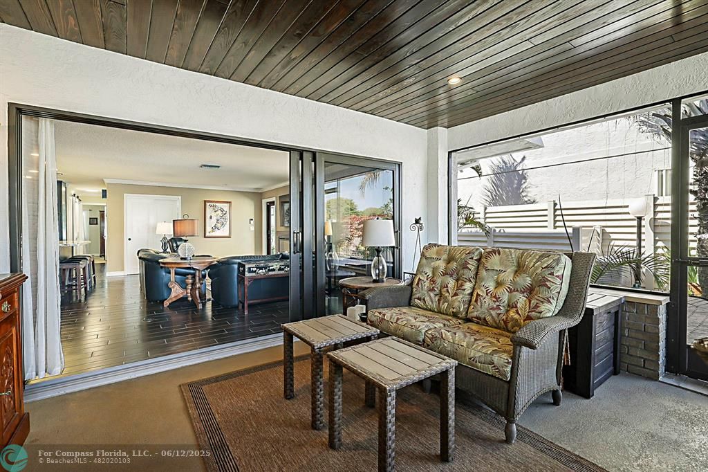 2743 Northeast 28th Court, Unit 3 Lighthouse Point, FL 33064 - Photo 21 of 56 a living room with furniture and a table