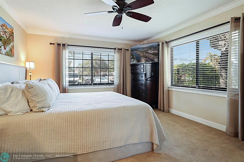 2743 Northeast 28th Court, Unit 3 Lighthouse Point, FL 33064 - Photo 24 of 56 a bedroom with a large bed and a window