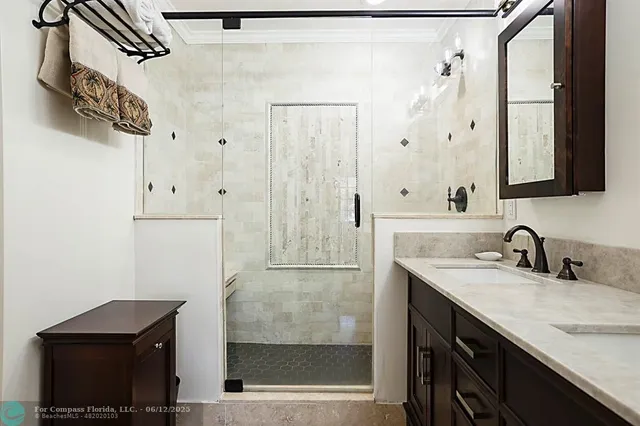 a bathroom with a sink vanity mirror and toilet