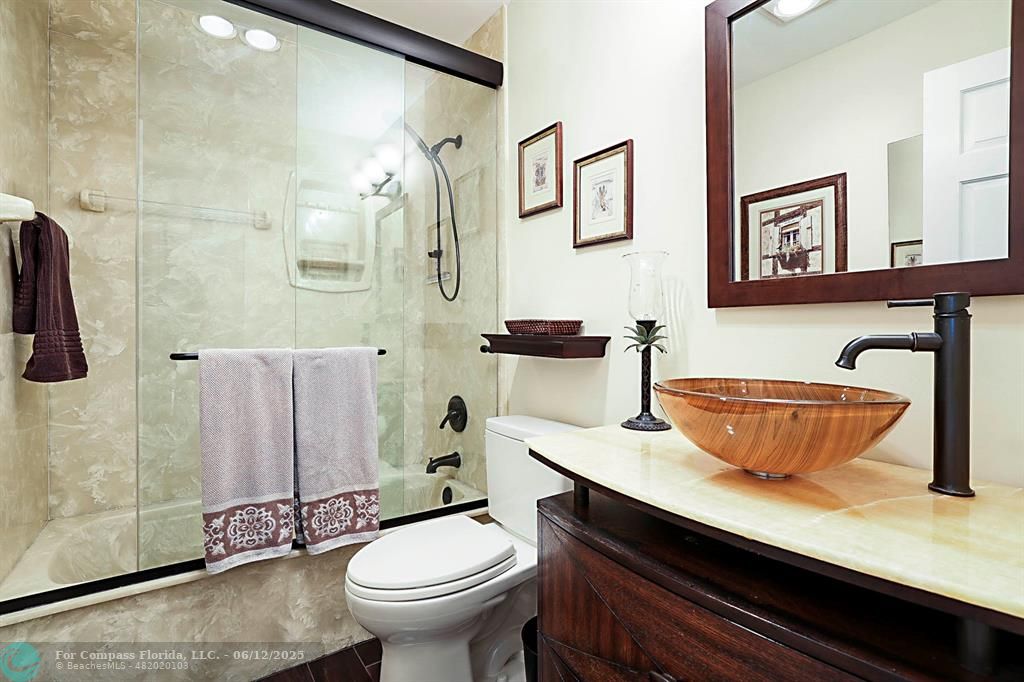 2743 Northeast 28th Court, Unit 3 Lighthouse Point, FL 33064 - Photo 30 of 56 a bathroom with a granite countertop sink and a mirror