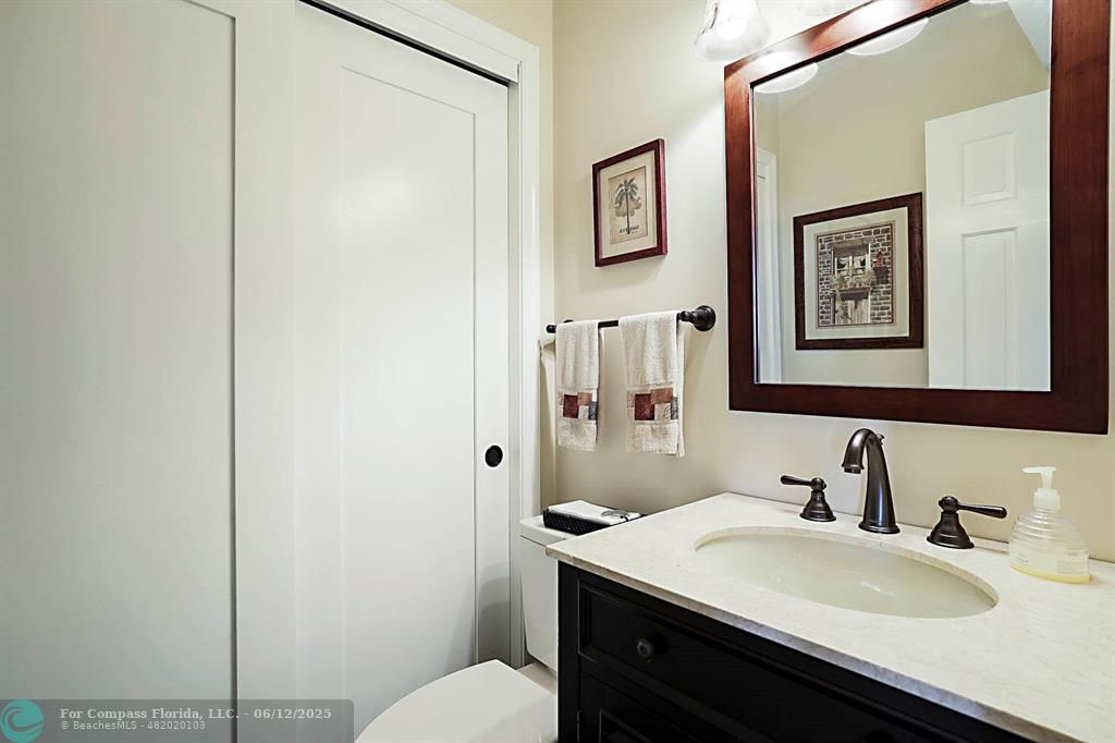 2743 Northeast 28th Court, Unit 3 Lighthouse Point, FL 33064 - Photo 33 of 56 a bathroom with a sink vanity mirror and toilet