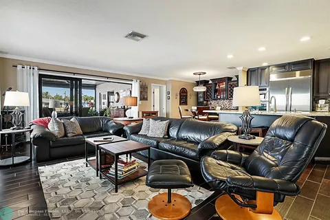 a living room with furniture a rug and a window