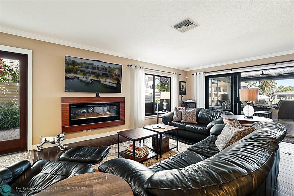 2743 Northeast 28th Court, Unit 3 Lighthouse Point, FL 33064 - Photo 7 of 56 a living room with furniture and a fireplace