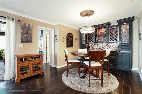 a view of a dining room with furniture wooden floor and chandelier