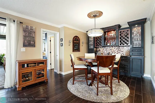 a view of a dining room with furniture wooden floor and chandelier
