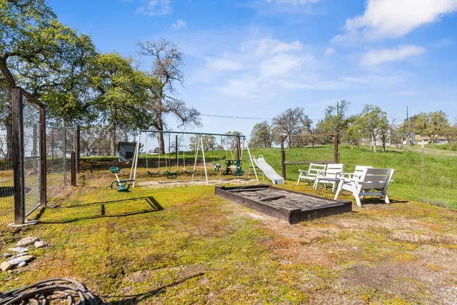 a view of a swimming pool with lounge chairs in patio