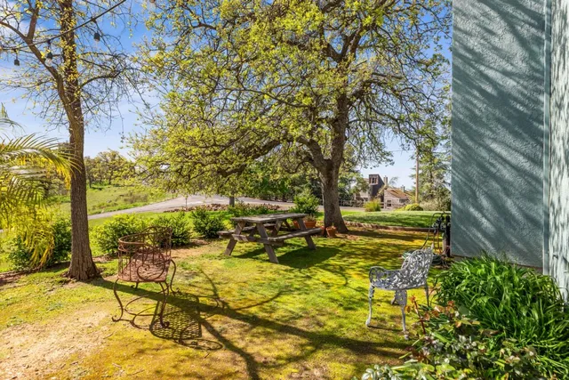 a view of a backyard with sitting area