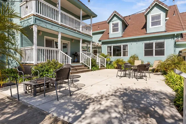 a view of a patio with table and chairs and potted plants
