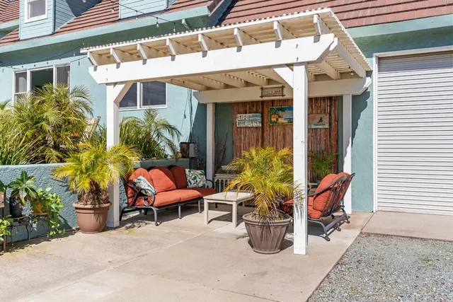 a view of a patio with table and chairs and wooden floor