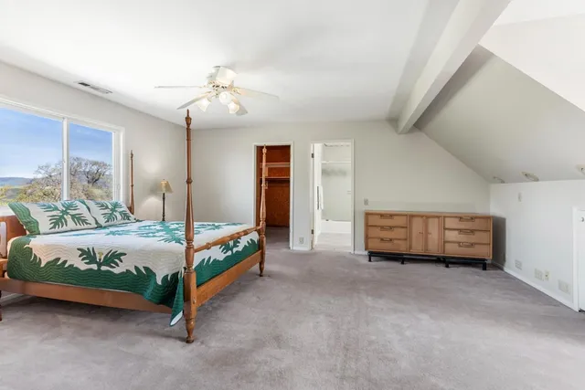 a spacious bedroom with a bed and window